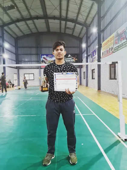 Himanshu Negi with his trophy and certificate after securing a bronze medal in the Mixed Doubles category at the UP State Badminton Championship.