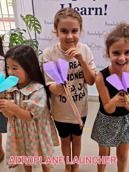 So much excitement! These young aviators are thrilled to test the paper airplanes they made with their custom-built launchers.
