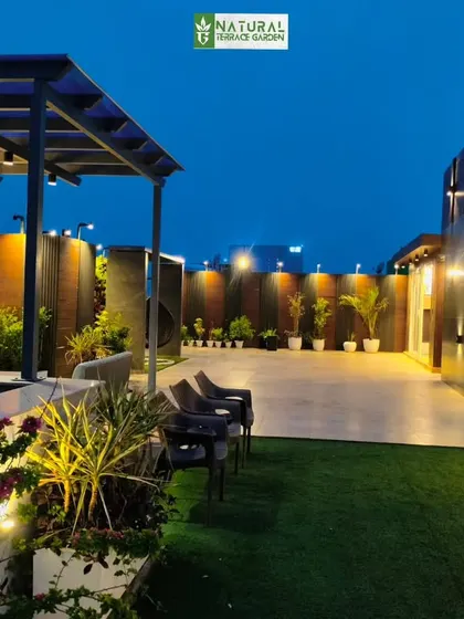 An evening view of the Sushant Lok project, with all the landscape lighting turned on, creating a magical atmosphere.