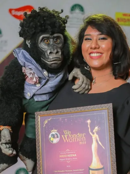 Nikki and I proudly holding our 'We Wonder Women' award. This award celebrates our unique contribution to the entertainment field.