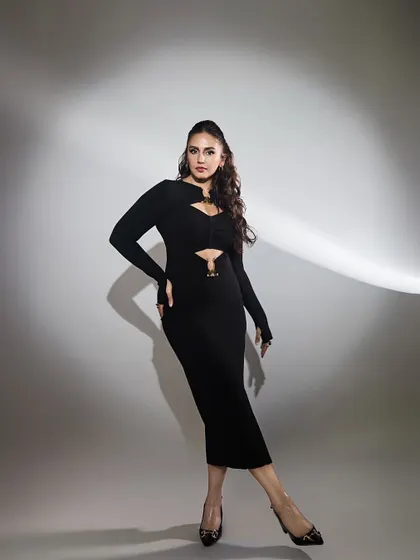 The full silhouette of Huma's power dress. The strategic cutouts and long sleeves create a look that is both sophisticated and daring.