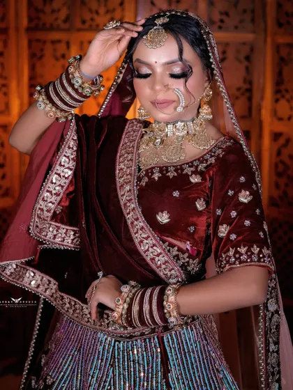 A serene portrait with the bride's eyes closed. The focus is on her calm expression and the beautiful details of her makeup and jewellery.