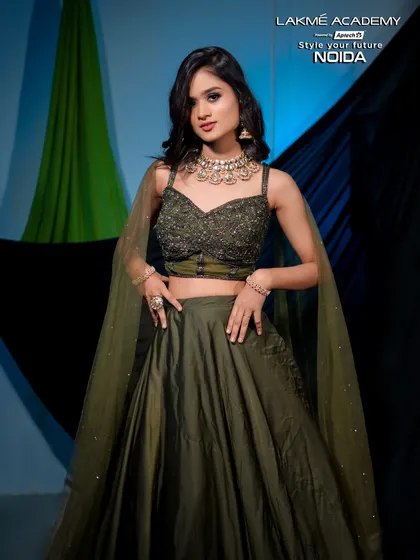 A full-length shot of a modern lehenga look. The olive green color is unique and stylish, and the makeup is done to complement it perfectly.