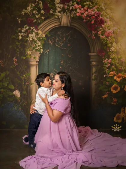 A tender kiss for mom. These are the precious, unscripted moments with older siblings that make a family maternity shoot so special.