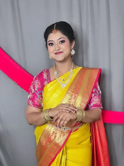 The complete look for this family function. The bright yellow saree is balanced with a soft, glowing makeup look, making her look graceful and festive.