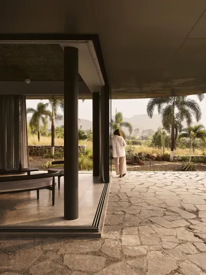 A quiet moment on the veranda of Pavilion House, looking out over the semi-arid landscape of Nashik. Our designs always prioritize a connection to the surroundings.