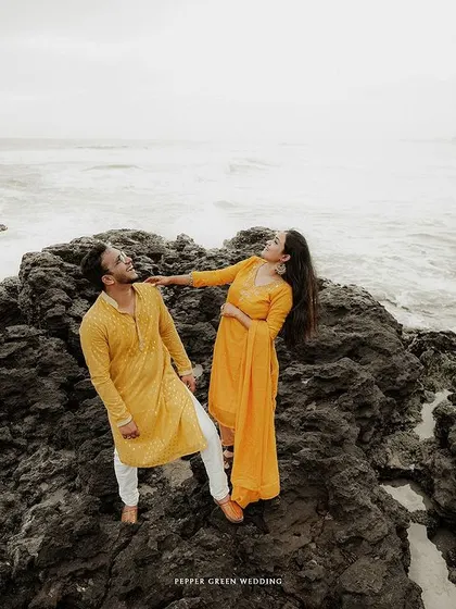A playful moment for Aiswarya and Vishnu on the rocky shore. Capturing these fun, unscripted interactions is key to telling an authentic story.