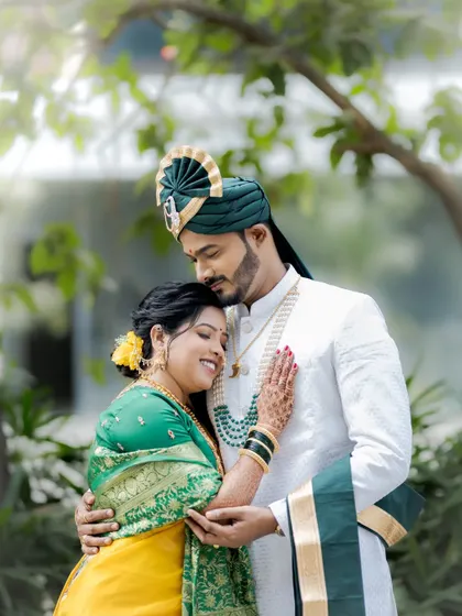 An intimate embrace, with the bride resting peacefully in the groom's arms, captured with soft, natural lighting.