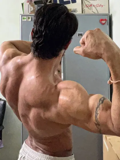 A close up of the back pose, focusing on the muscle detail. Every fiber is a result of struggle and effort.