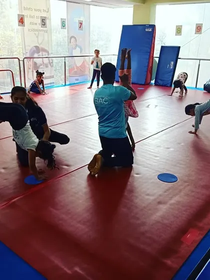 A Friday evening class with our "Good Friends" group. The images show a variety of activities, from warm-up exercises to practicing cartwheels with instructor support.