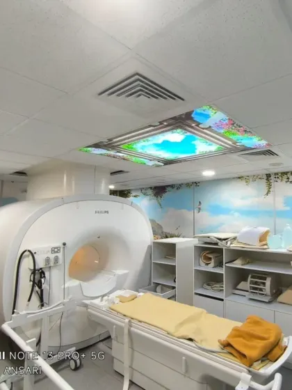 A custom wallpaper installation in a hospital's MRI room. The calming sky and nature scenes on the walls and ceiling help create a less stressful environment for patients.