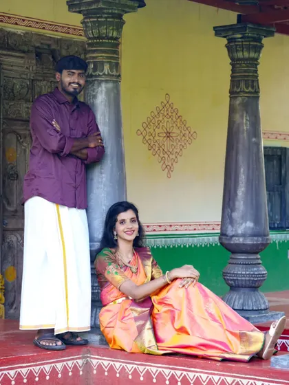 A classic couple's portrait in a traditional setting. The architecture and their attire create a timeless and culturally rich photograph.