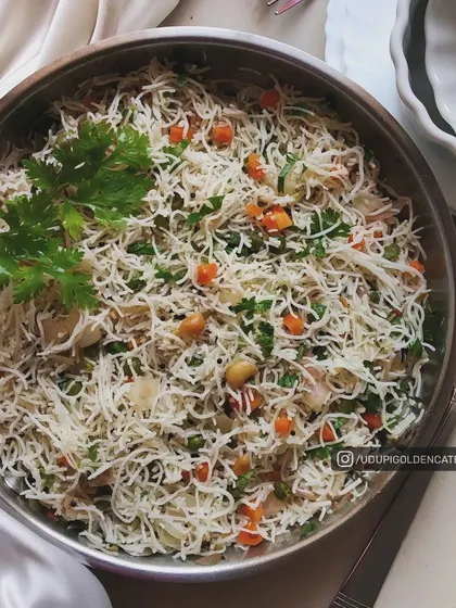 This is our Shavige Bath, or vermicelli upma, prepared with fine rice noodles, vegetables, and peanuts. It's a light yet satisfying dish for breakfast or a light meal.