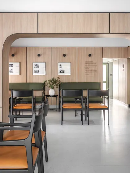 The main waiting hall is organized to provide a sense of personal space while maintaining an open feel. The arrangement of seating encourages quiet reflection before an appointment.