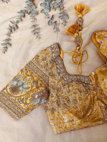 A self-brocade yellow masterpiece hand-embellished with delicate zardozi, beadwork, and sequins.