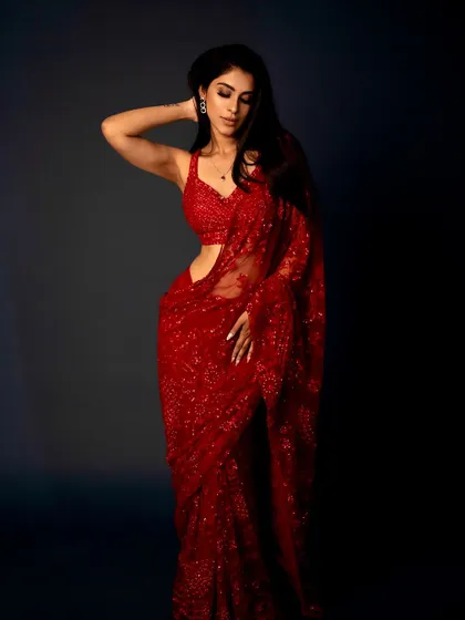 This pose shows off the beautiful drape of the saree and the elegant makeup. The soft waves in the hair complete this chic and modern ethnic look.