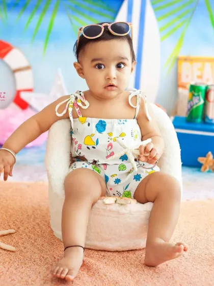 Chilling in his little chair with his sunglasses on. This beach theme is full of cool and playful details for a memorable first birthday shoot.