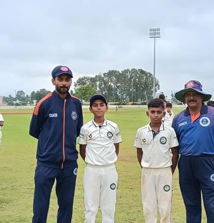 Coaches stand with players from the U-12 and U-16 age groups.