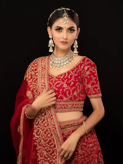 This model looks stunning in a red lehenga and a simple yet elegant Kundan choker. It's a perfect choice for a minimalist bride or a wedding guest.