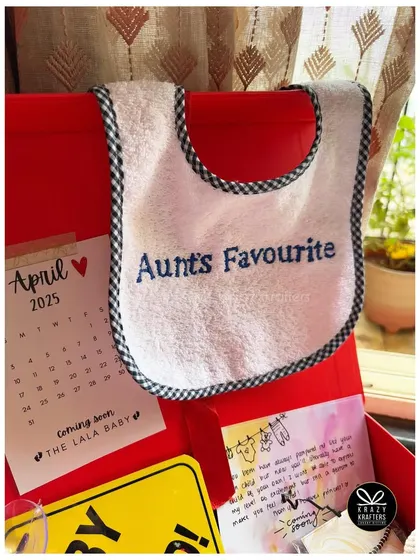 A custom bib that proudly declares the baby is 'Aunt's Favourite'. We can personalize bibs and robes with any cute nickname or phrase.
