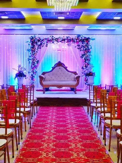 A full view of the Celebration banquet hall in Juinagar, set up for a wedding. The red carpet and floral stage create a festive look in this budget-friendly venue.