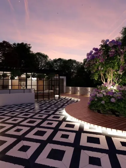 A beautiful evening view from a 3D design, showcasing a curved wooden deck with integrated lighting around a feature tree, and a glass room in the background.