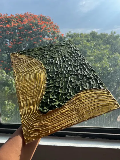 A finished piece from our textured art workshop. Using special materials, we create stunning 3D effects that you can feel. This one, with its green and gold design, looks incredible in the light.
