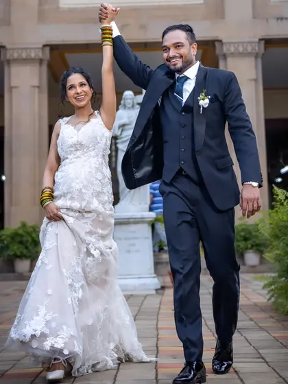 Just married. This joyful shot captures the couple's excitement as they walk out of the church, with the bride's curly hair and beautiful gown on full display.