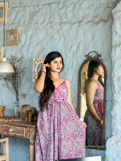A collection of relaxed, bohemian-style portraits taken at a rustic cafe. The model is featured in a flowing paisley dress, interacting with props like a guitar, creating a natural and artistic vibe.