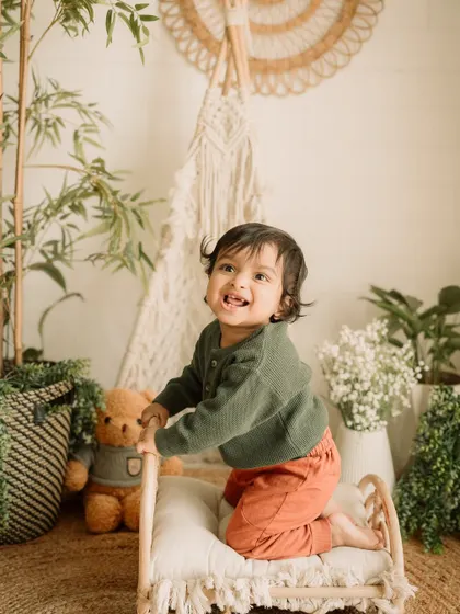 A moment of pure excitement as this toddler climbs onto the mini-bed prop in the studio.