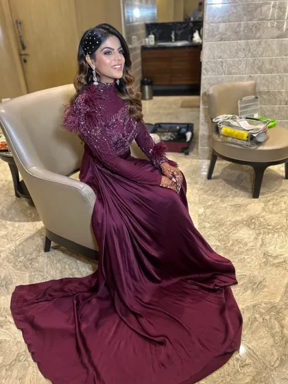 For this engagement bride, I created dramatic, voluminous waves to match her stunning maroon gown. The hair is swept to one side and accented with a sparkling accessory.