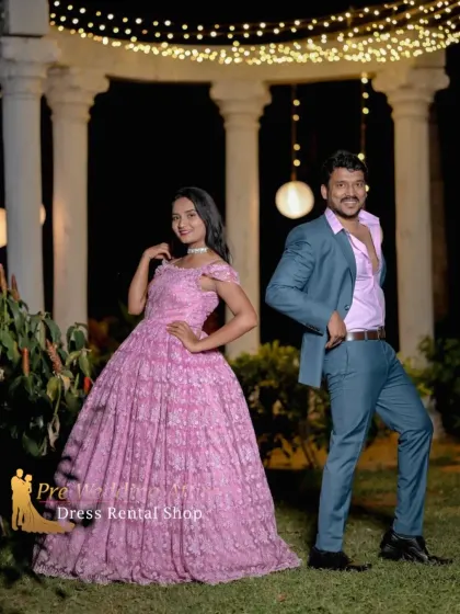 This playful shot shows a couple in a pink ball gown and a teal suit. The outfits are versatile enough for both formal and more relaxed, fun poses.