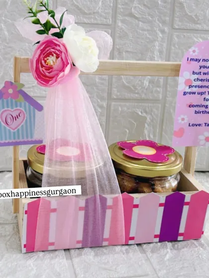 This pink-themed first birthday return favor for Taarini features a birdhouse design, jars of cookies, and a sweet thank you message from the birthday girl.