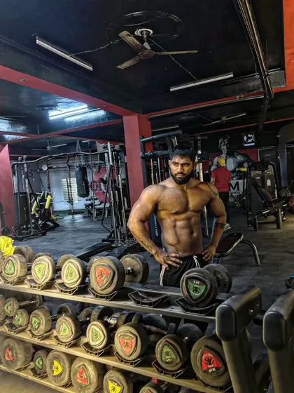 Dream big, pose bigger. A classic pose in front of the dumbbell rack. This is where dreams are built.