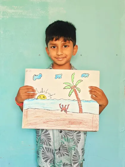 A proud artist holding his beach scene drawing. We teach simple techniques to create beautiful landscapes.
