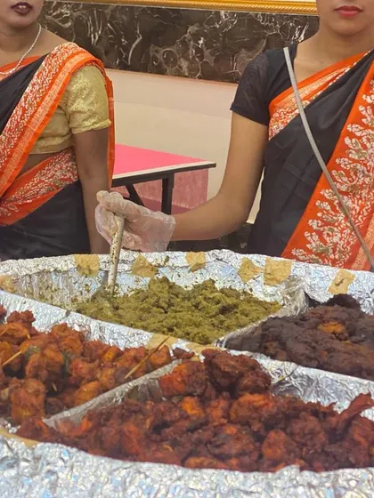 A close-up of our assorted non-vegetarian starters, a crowd favorite at wedding receptions. This platter features a variety of kebabs and fried items, each seasoned and cooked to perfection by our expert chefs.