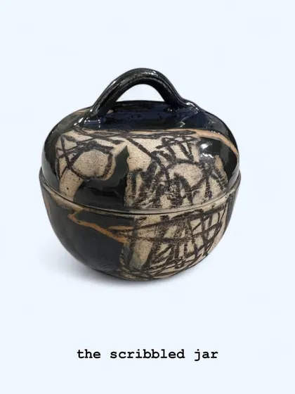 'The Scribbled Jar', a hand-built lidded pot with an abstract, expressive surface decoration. This piece is perfect for storing small treasures or as a standalone piece of ceramic art.