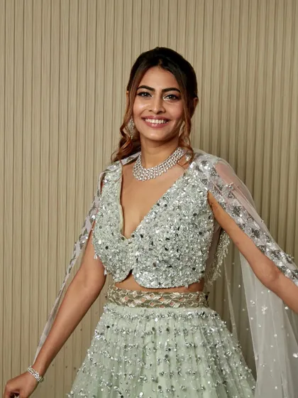 A full-length view of the sparkling outfit and the elegant hair and makeup that completes this glamorous cocktail look.
