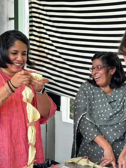 Laughter and learning go hand-in-hand at my workshops. Here, participants share a joyful moment while learning different tie-dye folding techniques.