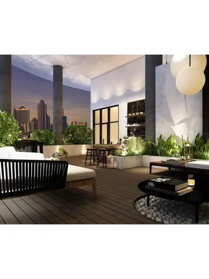 As evening sets in, this terrace transforms into a magical space with glowing spherical lights and illuminated planters, set against the city skyline.