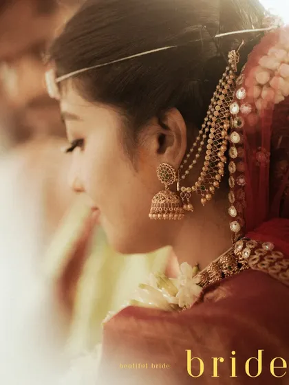 A soft and dreamy profile shot of a Hindu bride, her traditional jewelry and serene expression creating a beautiful, artistic portrait.