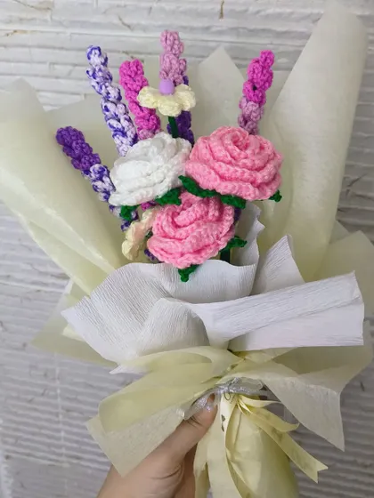A mixed bouquet of handmade flowers, featuring pink roses and lavender stems. We can create custom arrangements with your favorite flowers.