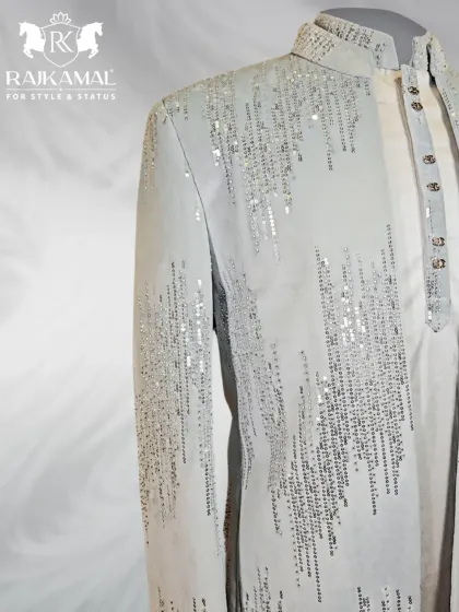 A side view of the sequined white Indo-Western jacket, showing how the light catches the embellishments.