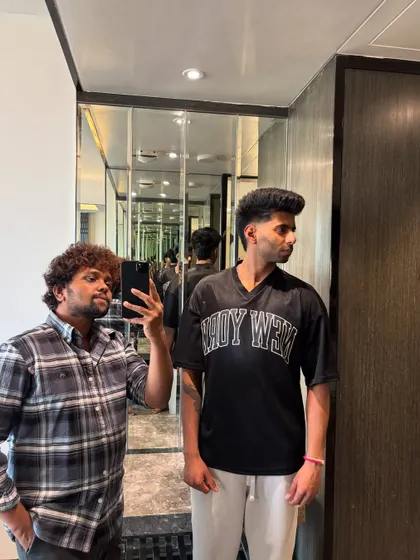 A profile view of Mayank Yadav's voluminous hair.