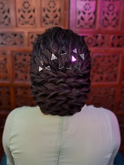 A modern and chic textured bun, decorated with geometric mirror accessories. This is a unique and artistic hairstyle for a contemporary bride or party-goer.