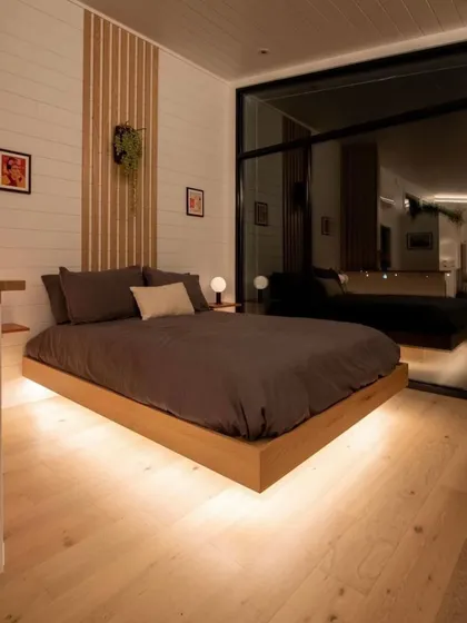 A floating bed with under-lighting is a great way to make a bedroom feel more spacious and modern. It's a design feature I often use to add a touch of style and ambiance.