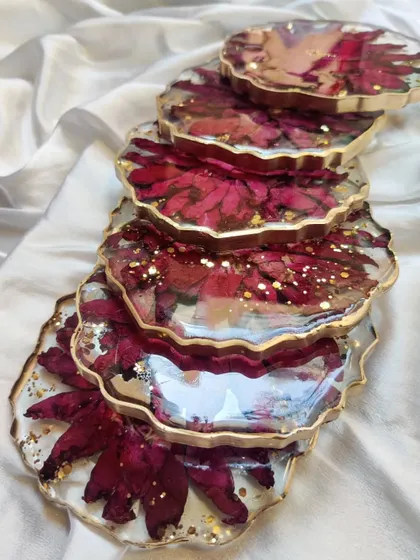 A stack of custom-made floral coasters, showing their depth and the beautiful, glossy finish. These are perfect for gifting or for adding a touch of elegance to your coffee table.