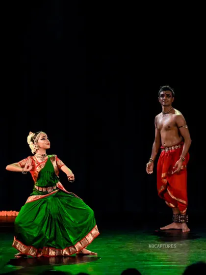 A full-stage view of 'SUTÃ', showing the dynamic between the two performers. The contrast in our costumes and postures tells a story of connection and guidance.