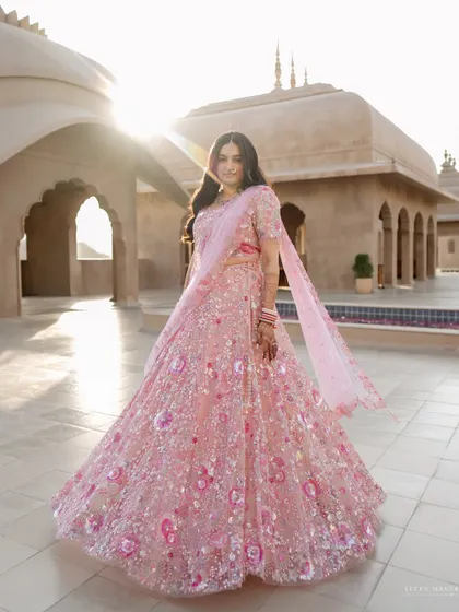 A stunning full-length portrait against the backdrop of Fairmont Jaipur. The sun flare adds a touch of magic to this regal shot.