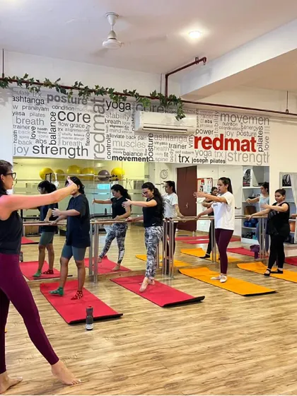A shot of our vibrant barre class, full of energy and smiling faces. It's a workout that feels like a party.